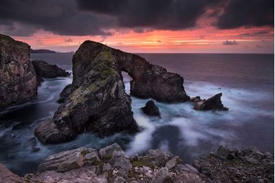 Natural rock archway at sunset, West Lewis, Scotland. 